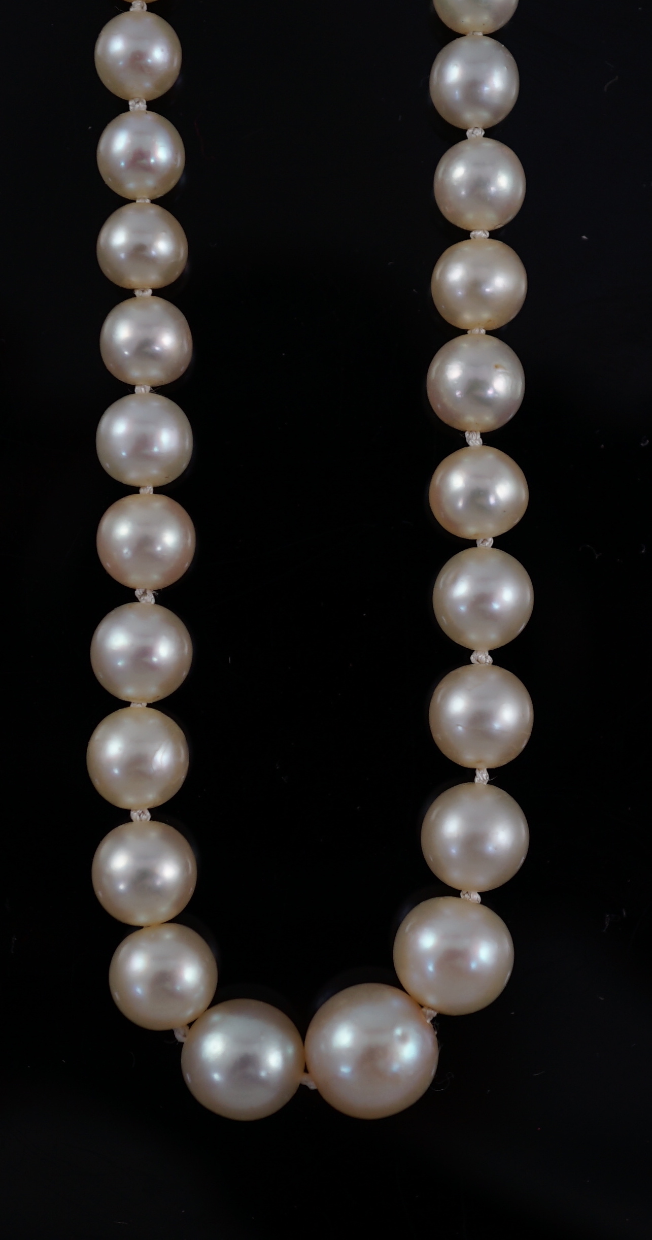 A late Victorian single strand graduated natural saltwater pearl necklace, with six stone old round cut diamond set silver and gold rectangular clasp